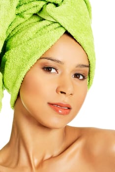 portrait of beautiful naked woman with turban. looking at camera. isolated on white.