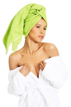attractive woman wrapped in towel with turabn. she is showing her shoulders. isolated on white.