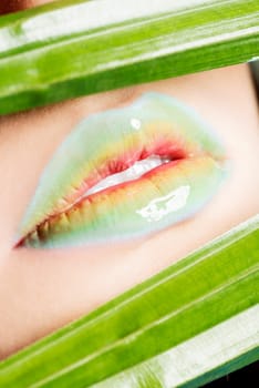 detailed closeup of female's lips. colorful makeup.