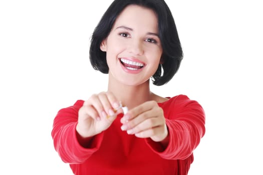 attractive woman holding a broken cigarette. isolated on white.