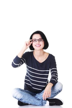 attractive woman in eyeglasses sitting crossed-leggedr. isolated on white.