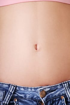 slim fit female's belly. closeup. isolated on white.