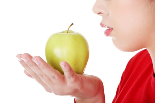 closeup of a woman's mouth and apple. isolated on white.