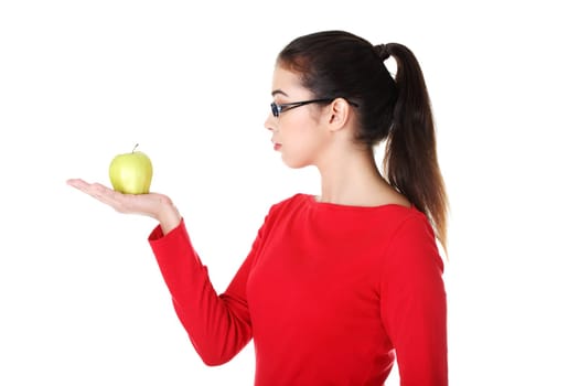 attractive woman in eyeglasses with apple on hand. isolated on white.
