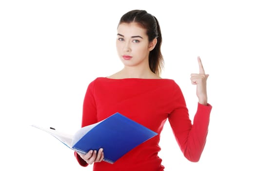 woman standing with files and pointing up. vertical. isolated on white.