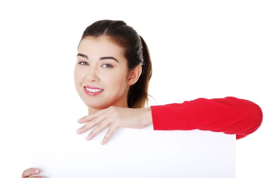 happy casual woman holding copy space. isolated on white.