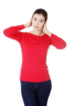 attractive young woman holding her head / covering her ears. isolated on white.