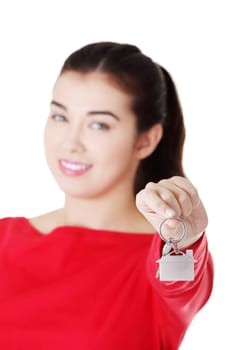 happy casual woman holding home keys. isolated on white.