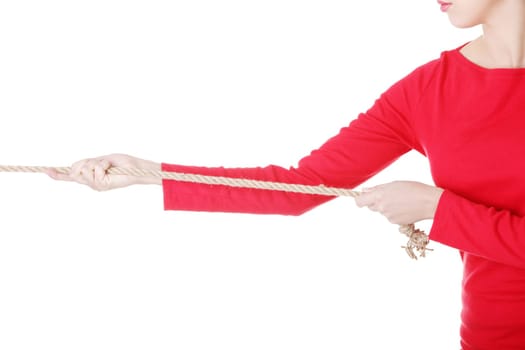 attractive young woman puuling a rope. isolated on white.