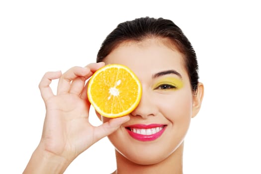 beautiful female's face with orange. isolated on white.