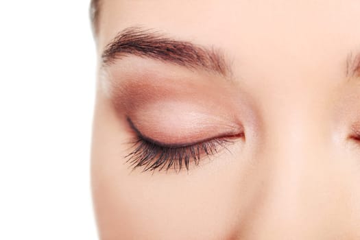 close up on female's face- eye. isolated on white.