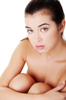 naked woman sitting holdig knees. up front view. isolated on white.