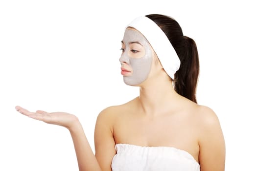 beautiful woman in towel with facial mask and headband. isolated on white.