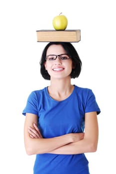 attractive woman with book and apple on head. isolated on white.
