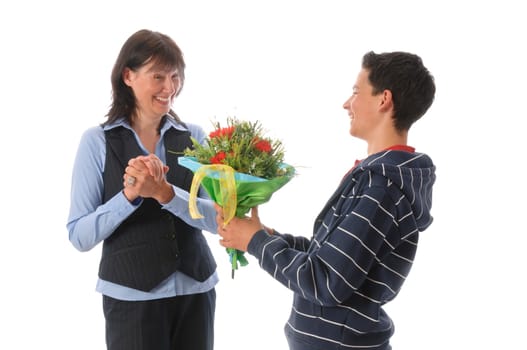 Mother and her teenage son,he presents her with a bouquet of flowers against a white background