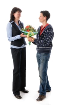 Mother and her teenage son,he presents her with a bouquet of flowers against a white background