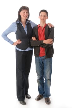 Mother and son stand next to each other,she embraces the boy in front of a white background.