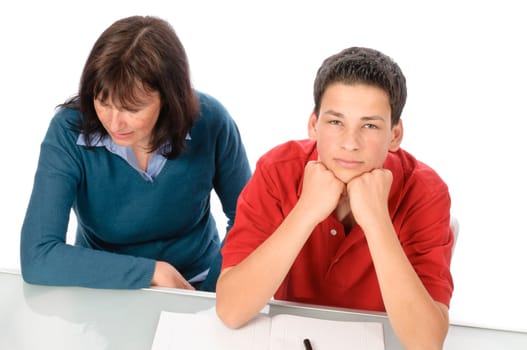 A grown woman,mother helps her son at the desk with homework,studying for the exam,against a white background.