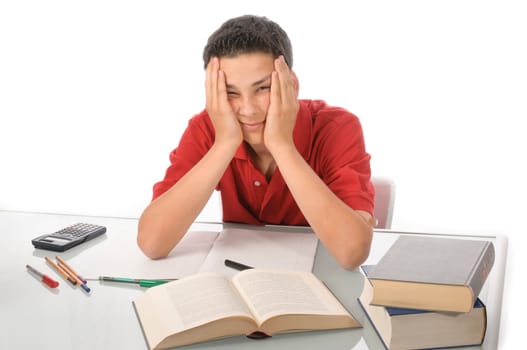 Boy sits exhausted and frustrated about homework at desk in front of a white background
