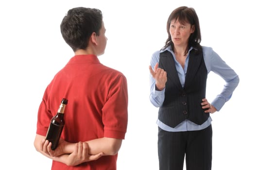 Mother catches her teenage son with a bottle of beer and scolds him against a white background.