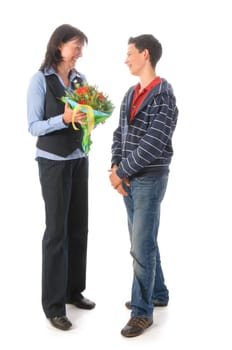 Mother and her teenage son,he presents her with a bouquet of flowers against a white background
