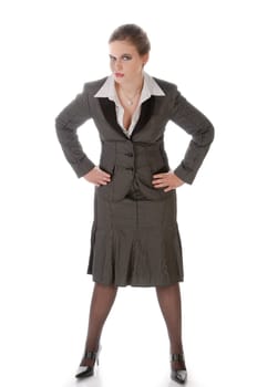 Young woman in grey business suit and high heels poses against a white background
