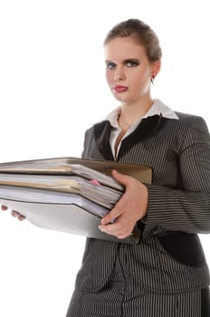 Young woman in a gray business suit and high heels carries a stack of files against a white background