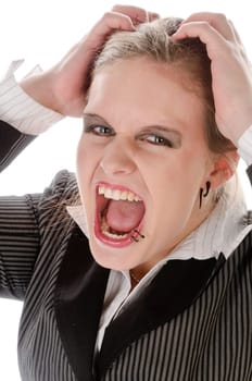 Young woman in grey business suit and high heels is stressed and ruffles her hair against a white background