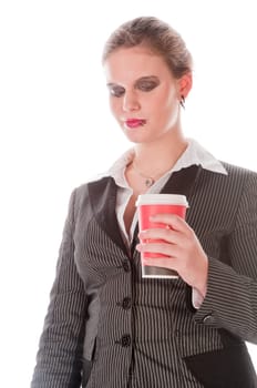 Young woman in grey business suit and high heels poses with coffee-to-go paper cups against a white background