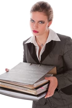 Young woman in a gray business suit and high heels carries a stack of files against a white background