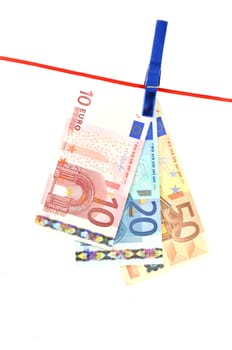 drying banknotes hanging on the rope isolated on white background