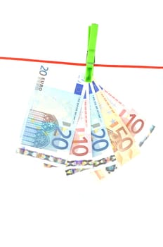 drying banknotes hanging on the rope isolated on white background