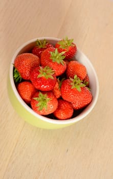 Fresh strawberries in a green bowl