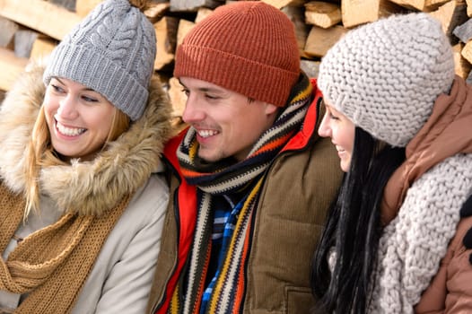 Three friends laughing winter outdoor warm clothes