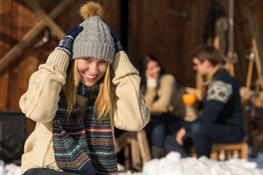Young woman in winter hat spend time in snow cottage