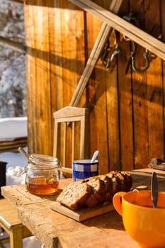 Snow winter cottage breakfast on wooden table