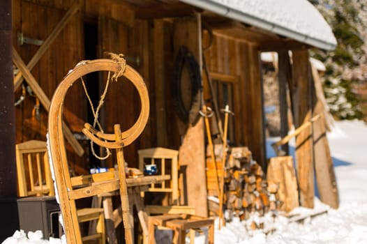 Winter snow cottage wooden sledge stand outside