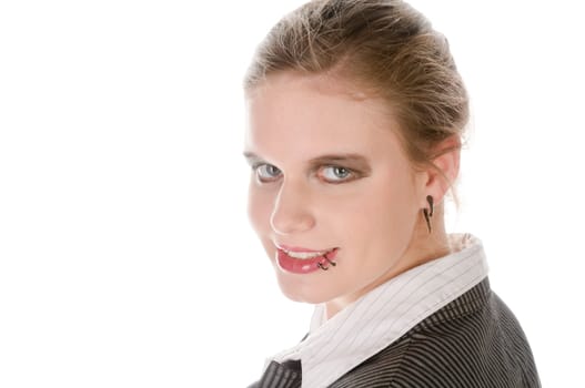 Young woman in grey business suit and high heels looks over her shoulder into the camera against a white background
