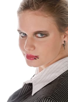 Young woman in grey business suit and high heels looks over her shoulder into the camera against a white background