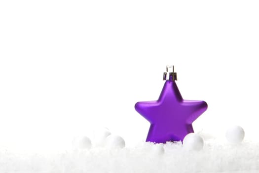 purple Christmas tree bauble as a poinsettia on snow