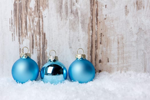 Christmas,decoration with wooden background,snow and Christmas baubles turquoise
