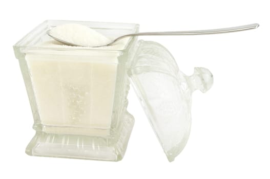 A spoonful of sugar and glass sugar bowl isolated on white.