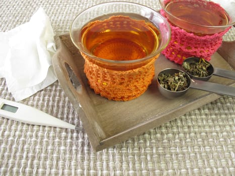 Cold tea in a glass with crocheted tea warmer