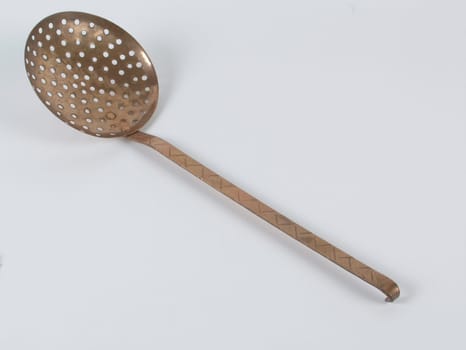 Professional ladle cookware made of copper against a white background