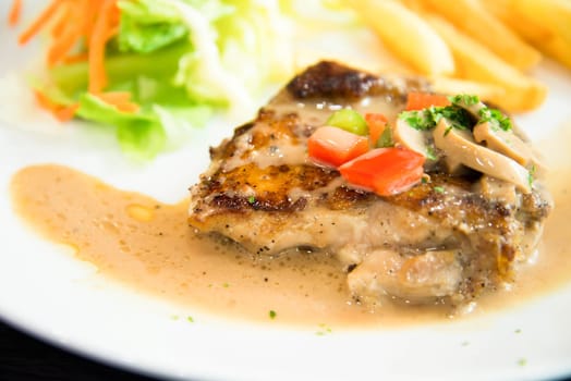 Delicious nourishing steak with vegetables, French fries.