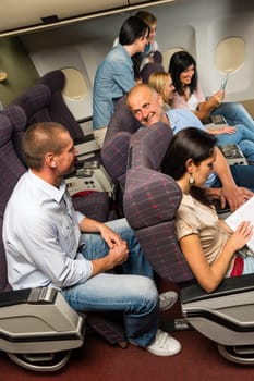 Leisure travel people enjoy flight airplane cabin talking passengers