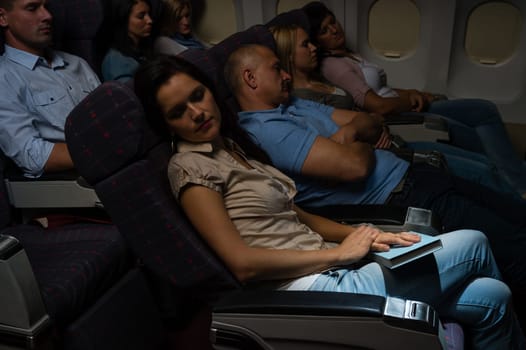 Flight passengers sleeping plane cabin night travel