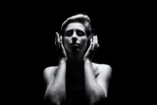 Young woman listens to music in black and white