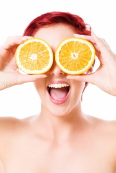 Enthusiastic young woman holds oranges in front of her eyes on a white background