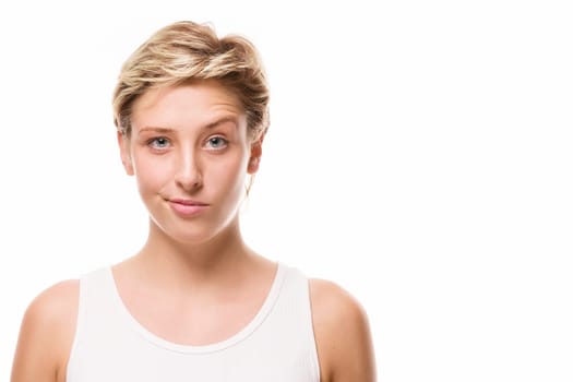 Young woman raises her eyebrow on a white background